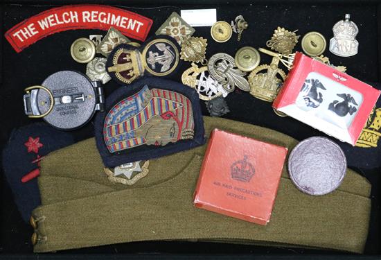 A collection of British military cap badges, buttons, etc.